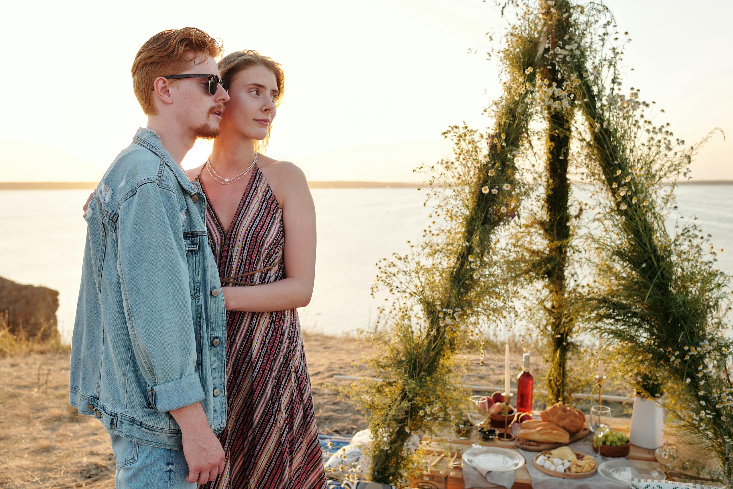 A Couple Standing Together Near the Table with Foods