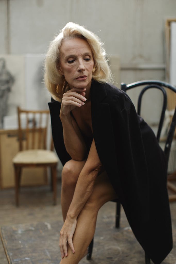 Lady in Black Coat Sitting on Black Chair